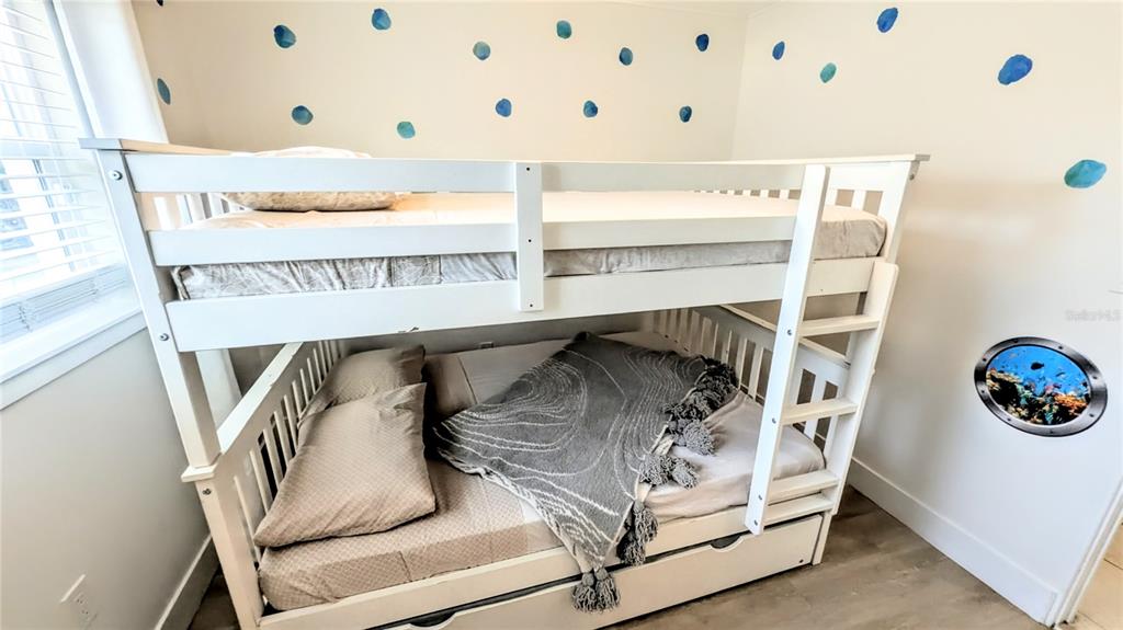 4515 Spahn Street Sarasota, FL 34232 - Photo 27 of 37 a bedroom with a bunk bed and a table