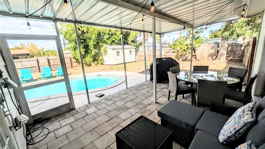 4515 Spahn Street Sarasota, FL 34232 - Photo 31 of 37 a view of a patio with a table chairs and a backyard