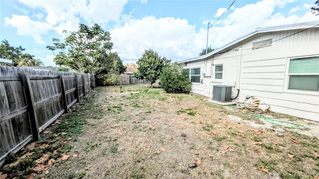 4515 Spahn Street Sarasota, FL 34232 - Photo 36 of 37 a view of a backyard with wooden fence and large trees