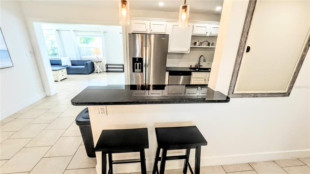 4515 Spahn Street Sarasota, FL 34232 - Photo 7 of 37 a kitchen with stainless steel appliances granite countertop a sink refrigerator and stove