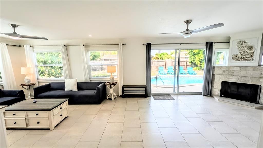 4515 Spahn Street Sarasota, FL 34232 - Photo 9 of 37 a living room with furniture and a fireplace