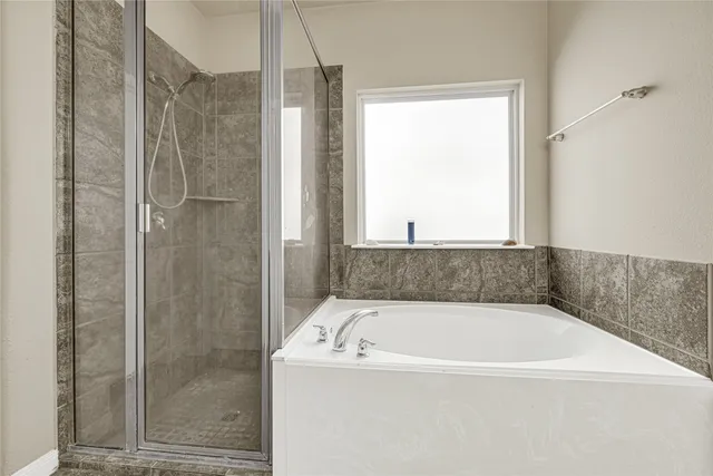 a bathroom with a bathtub and shower