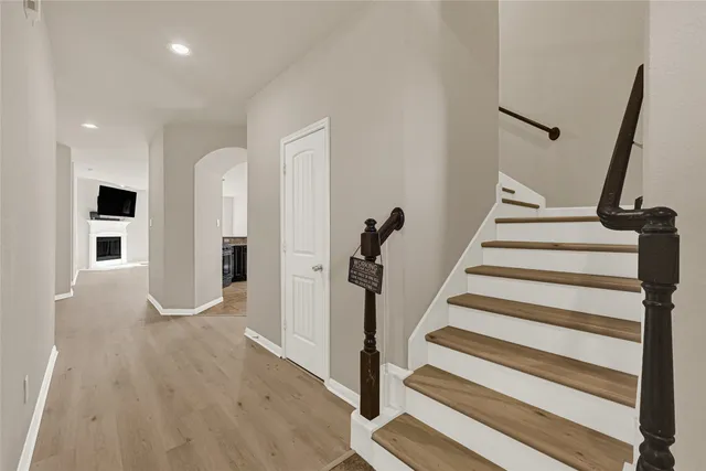 a view of entryway with wooden floor and stairs