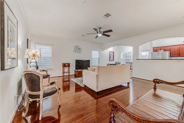 a living room with furniture and wooden floor
