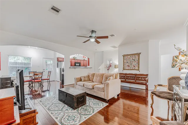 a living room with furniture and a wooden floor