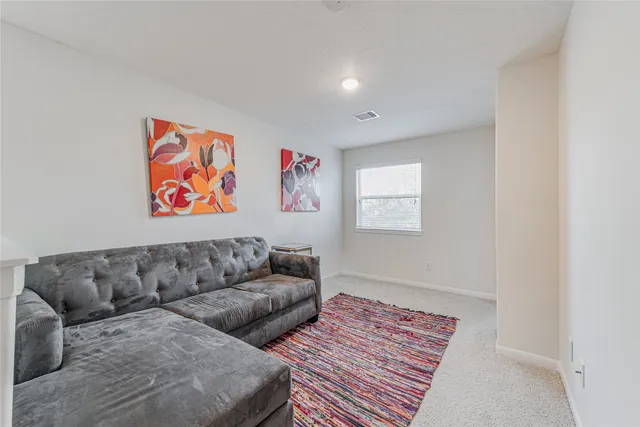 a living room with furniture and wall painting