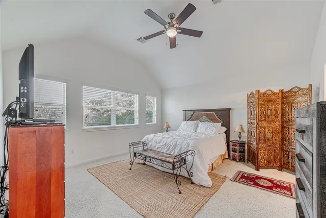 a bedroom with a bed a dresser and a book shelf