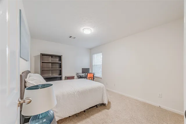 a bedroom with a bed and a chair