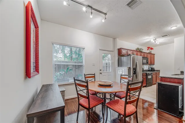 a view of a dining room with furniture and wooden floor