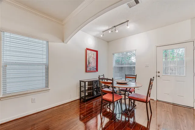 a living room with furniture and a wooden floor