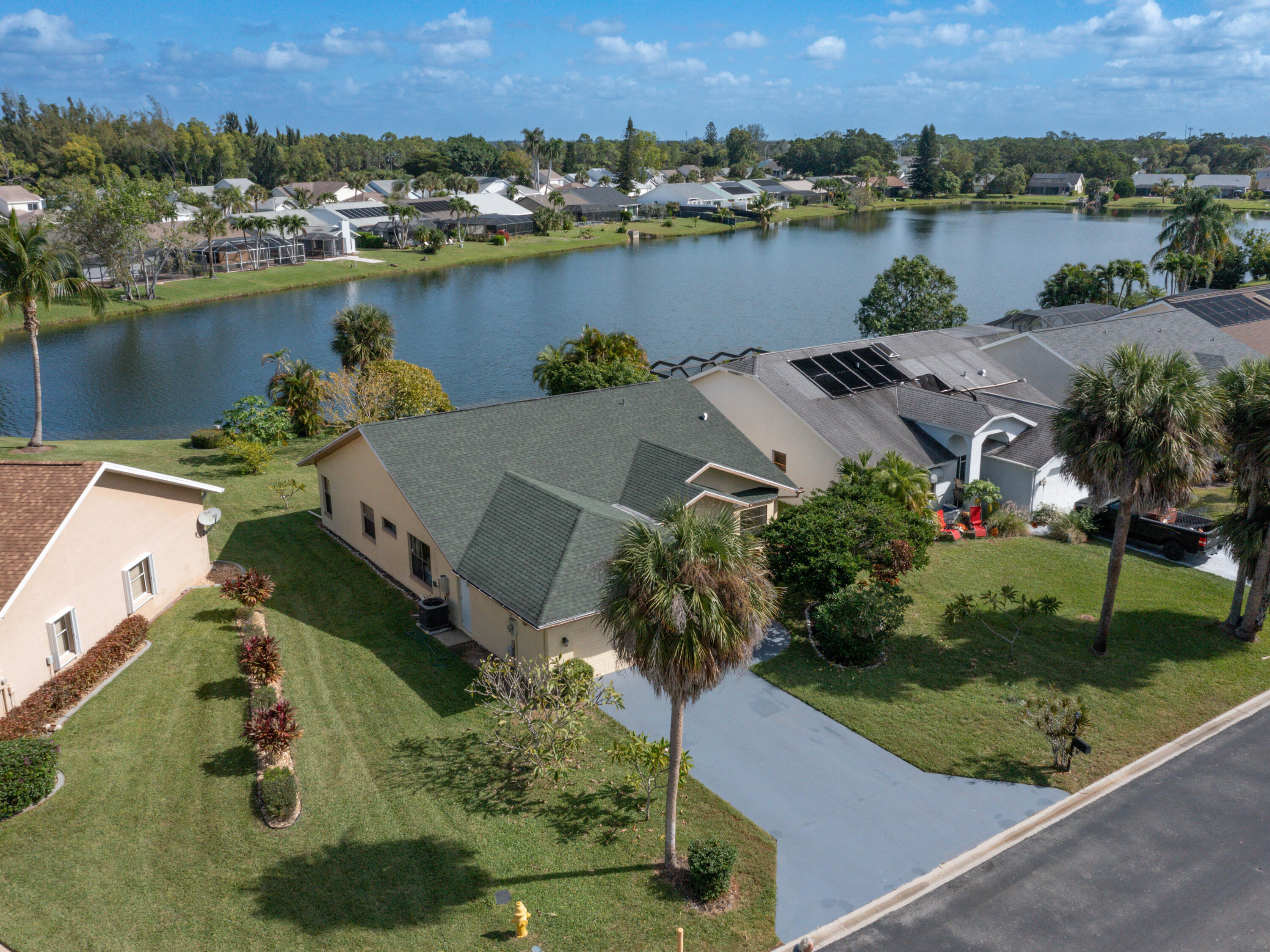 an aerial view of a house with outdoor space and lake view