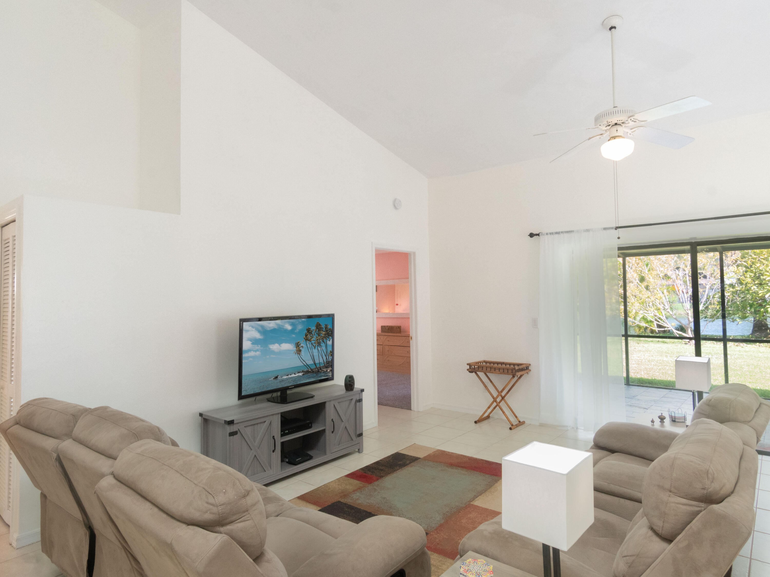 1404 Monarch Naples, FL 34116 - Photo 11 of 33 a living room with furniture and a flat screen tv