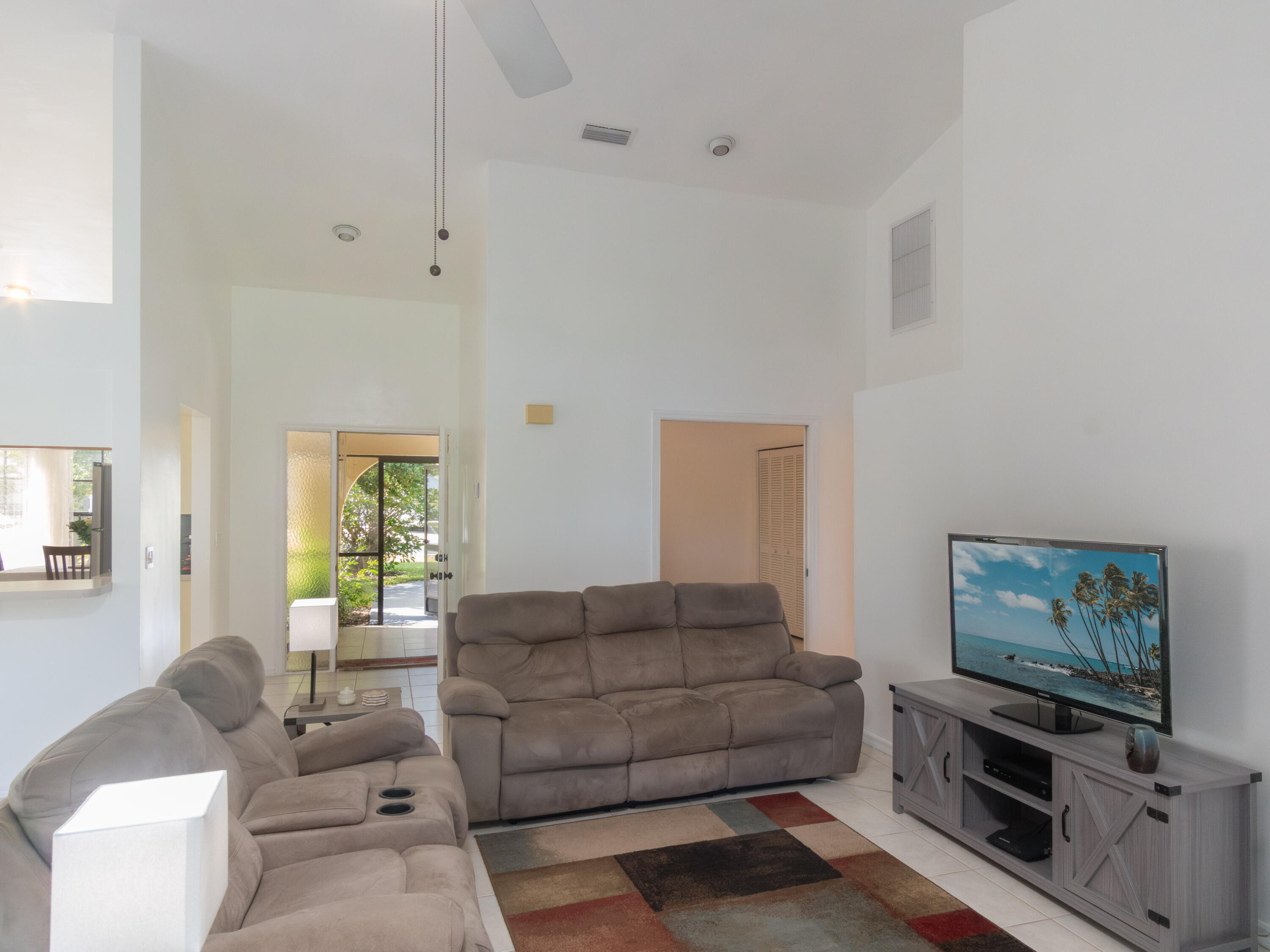 1404 Monarch Naples, FL 34116 - Photo 12 of 33 a living room with furniture and a flat screen tv