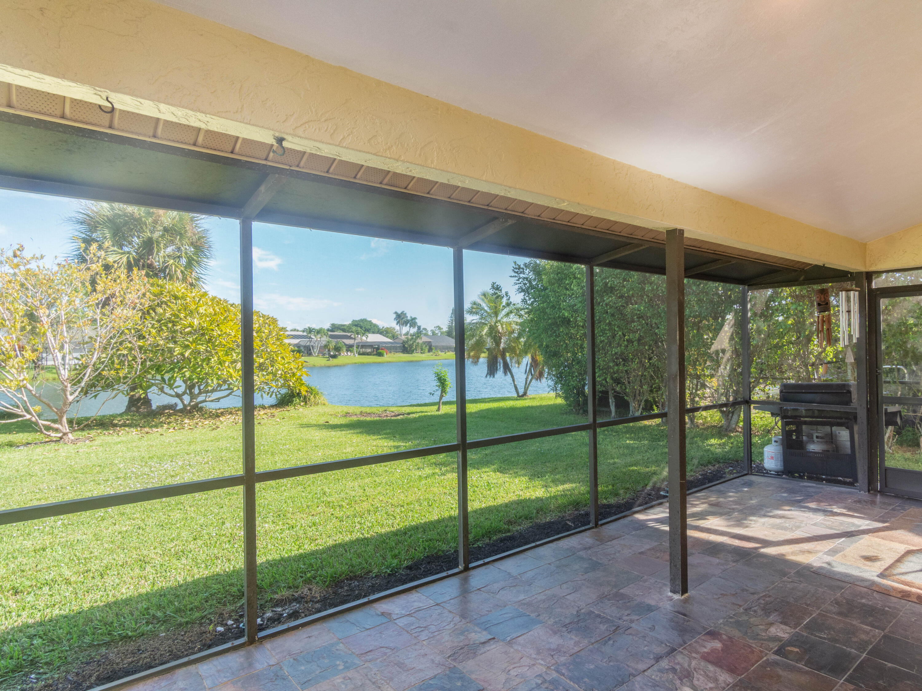 1404 Monarch Naples, FL 34116 - Photo 30 of 33 a view of a porch with a floor to ceiling window next to a yard