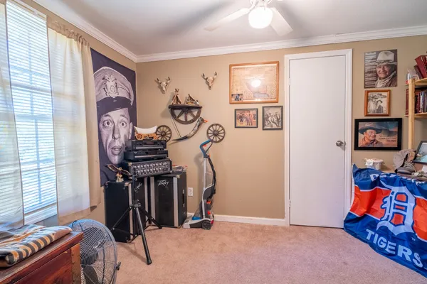 a bedroom with a bed a desk and chair