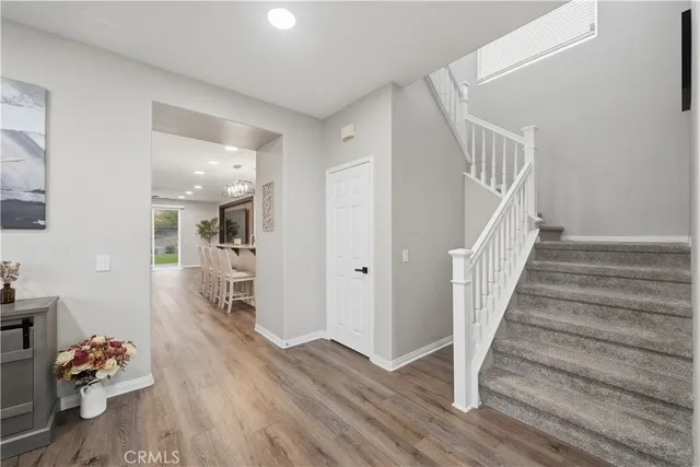 a kitchen with stainless steel appliances a dining table chairs and granite counter tops