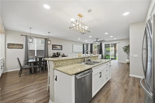 a dining room with furniture and wooden floor
