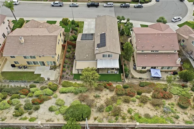 a view of a house with a yard and potted plants