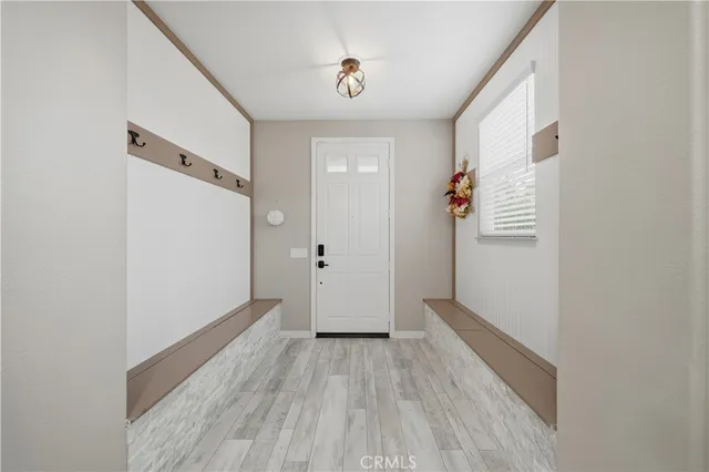 a view of a livingroom with wooden floor and stairs