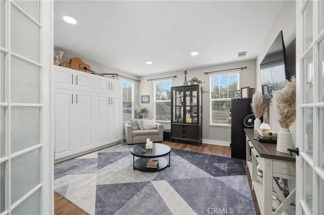 a living room with furniture and painting on the wall