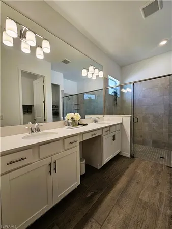 a bathroom with a shower and a sink