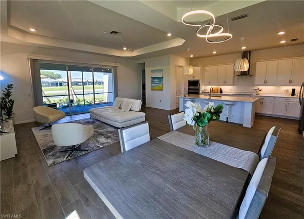 a kitchen with sink cabinets and chandelier