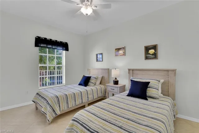a bedroom with two beds and a chandelier