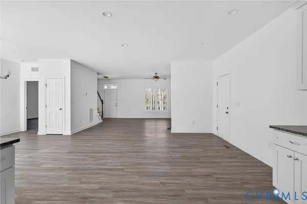 a kitchen with stainless steel appliances granite countertop a stove a sink and white cabinets