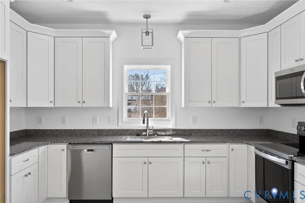 a kitchen with stainless steel appliances a refrigerator sink and cabinets
