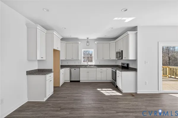 a view of a livingroom with wooden floor and a fireplace
