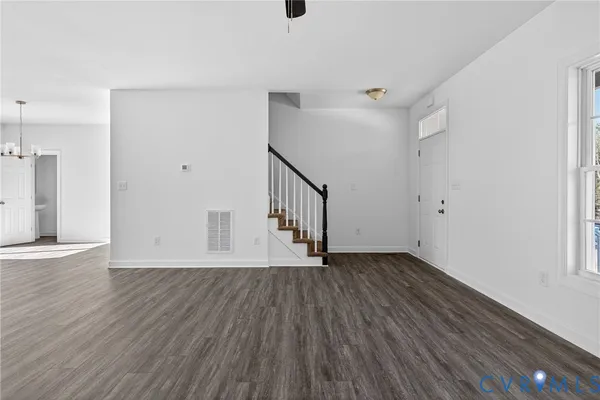 a view of empty room with wooden floor and fireplace