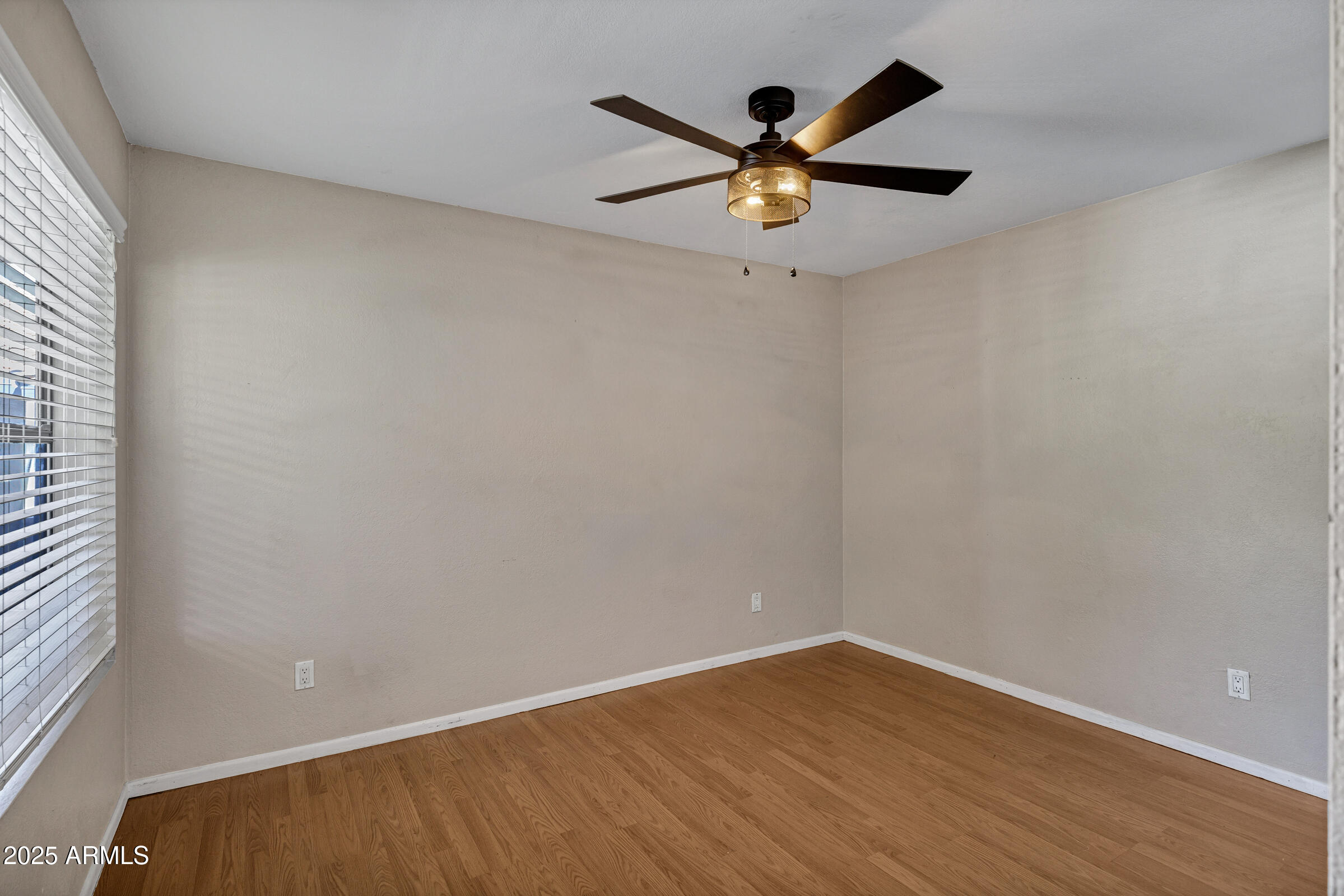 1402 East Guadalupe Road, Unit 248 Tempe, AZ 85283 - Photo 12 of 27 an empty room with wooden floor and windows