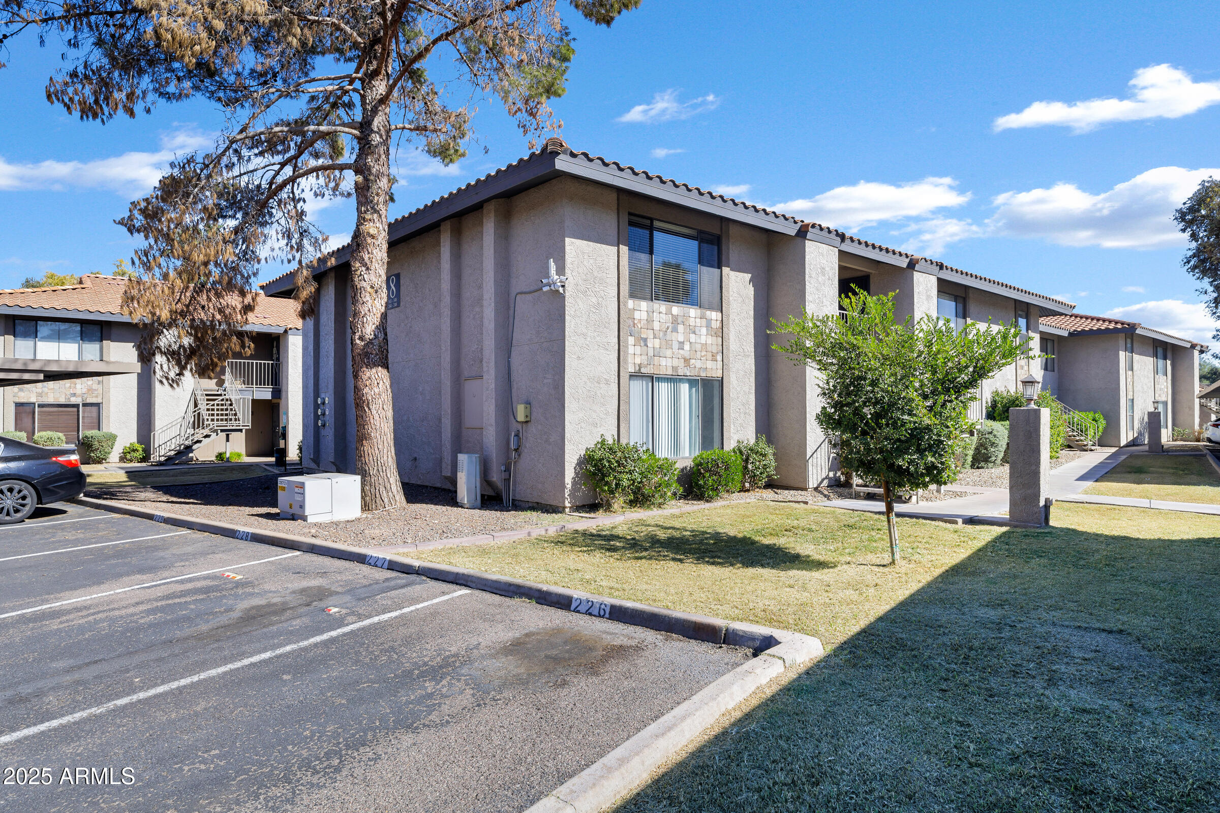 1402 East Guadalupe Road, Unit 248 Tempe, AZ 85283 - Photo 2 of 27 a view of a house with a patio and a yard