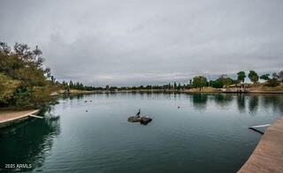 1402 East Guadalupe Road, Unit 248 Tempe, AZ 85283 - Photo 24 of 27 a view of a lake with houses in the back