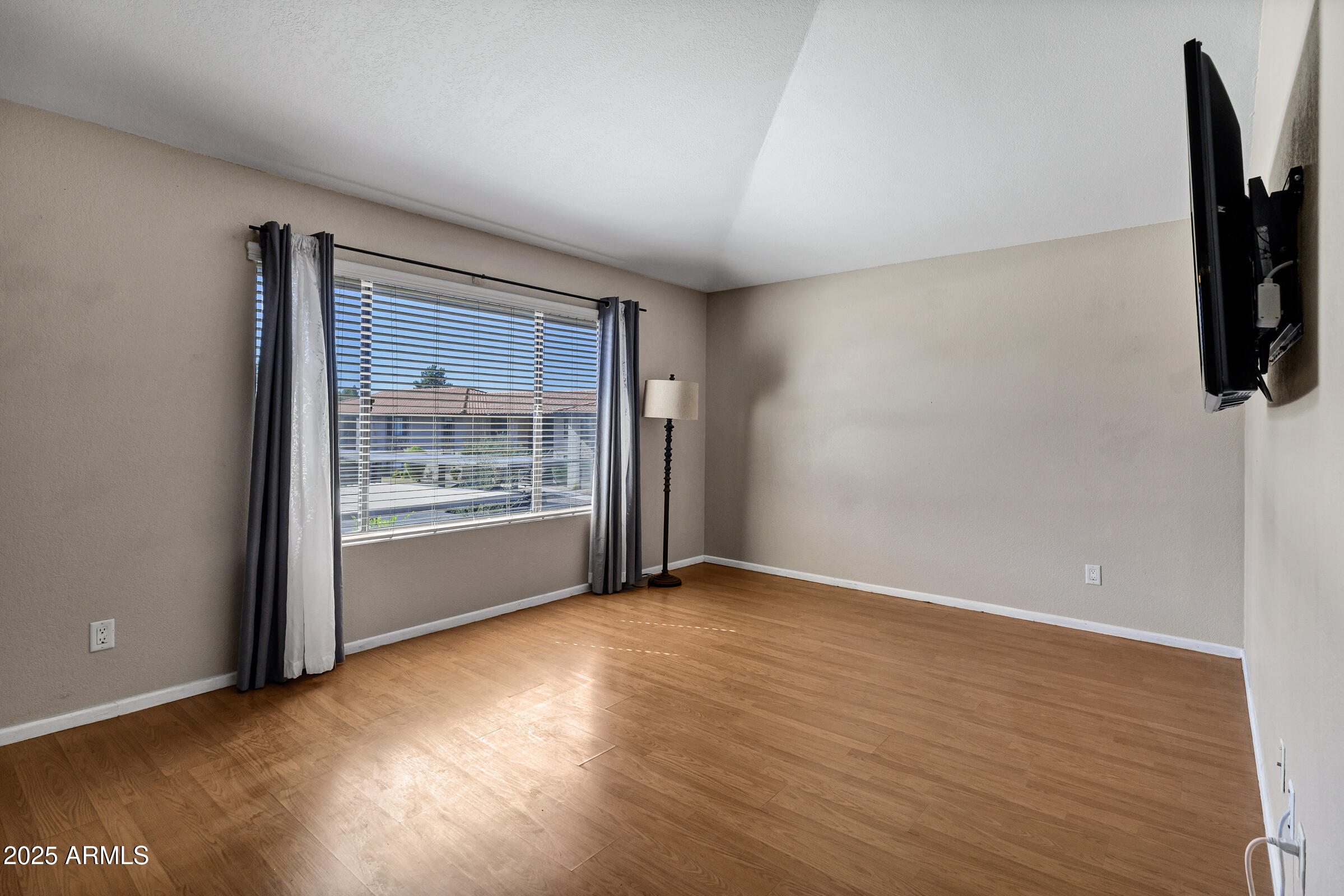 1402 East Guadalupe Road, Unit 248 Tempe, AZ 85283 - Photo 6 of 27 wooden floor in an empty room with a window