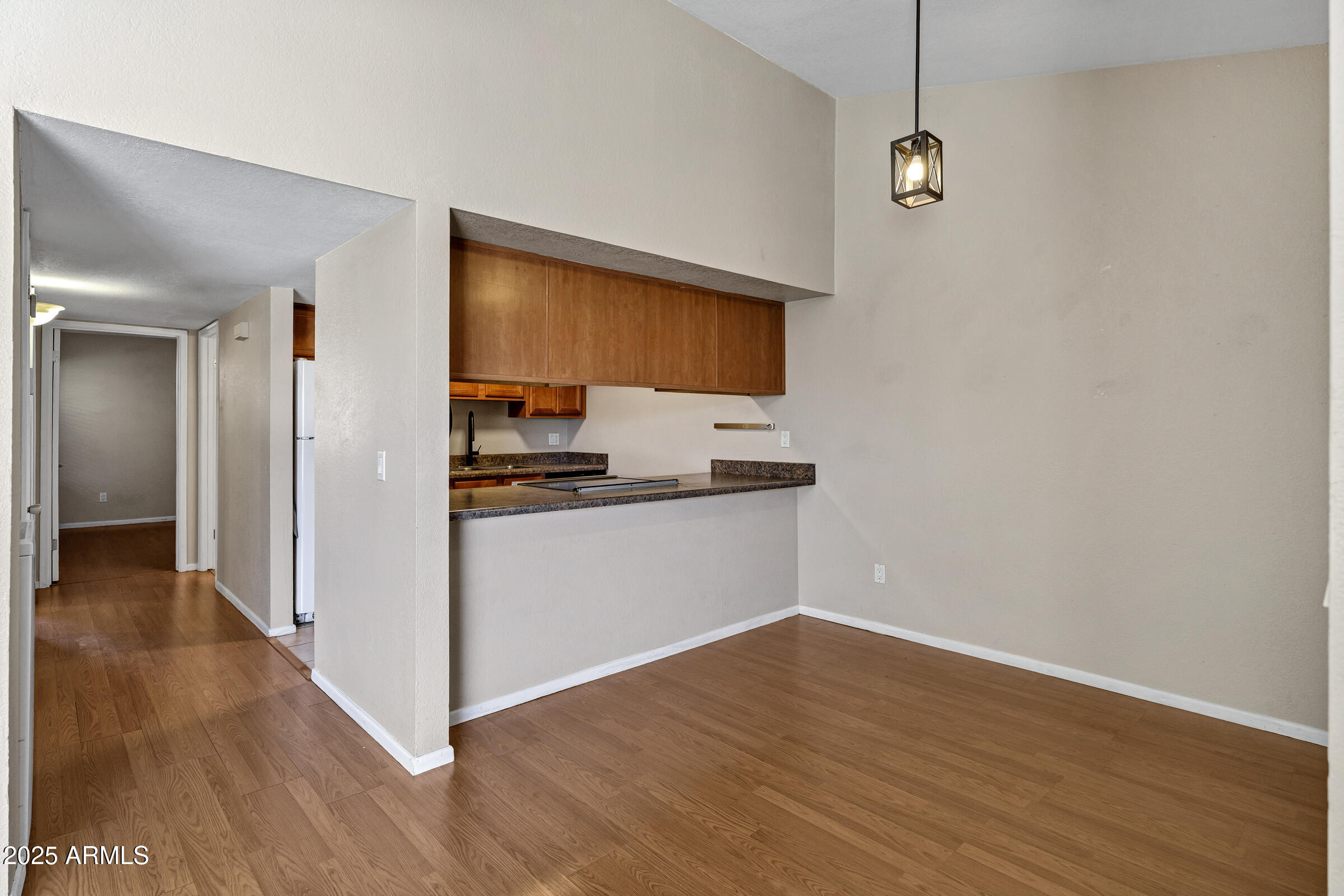 1402 East Guadalupe Road, Unit 248 Tempe, AZ 85283 - Photo 7 of 27 a view of empty room with wooden floor