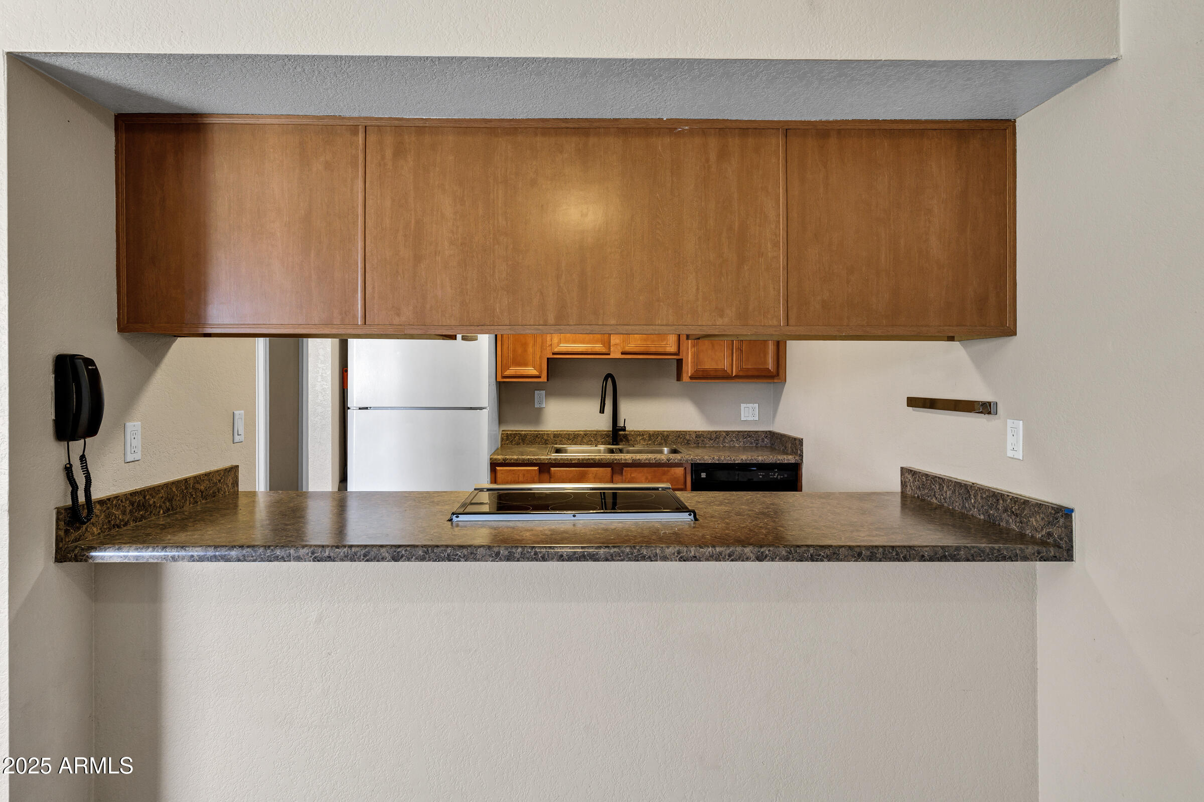 1402 East Guadalupe Road, Unit 248 Tempe, AZ 85283 - Photo 9 of 27 a kitchen with kitchen island granite countertop a sink and a stove top oven