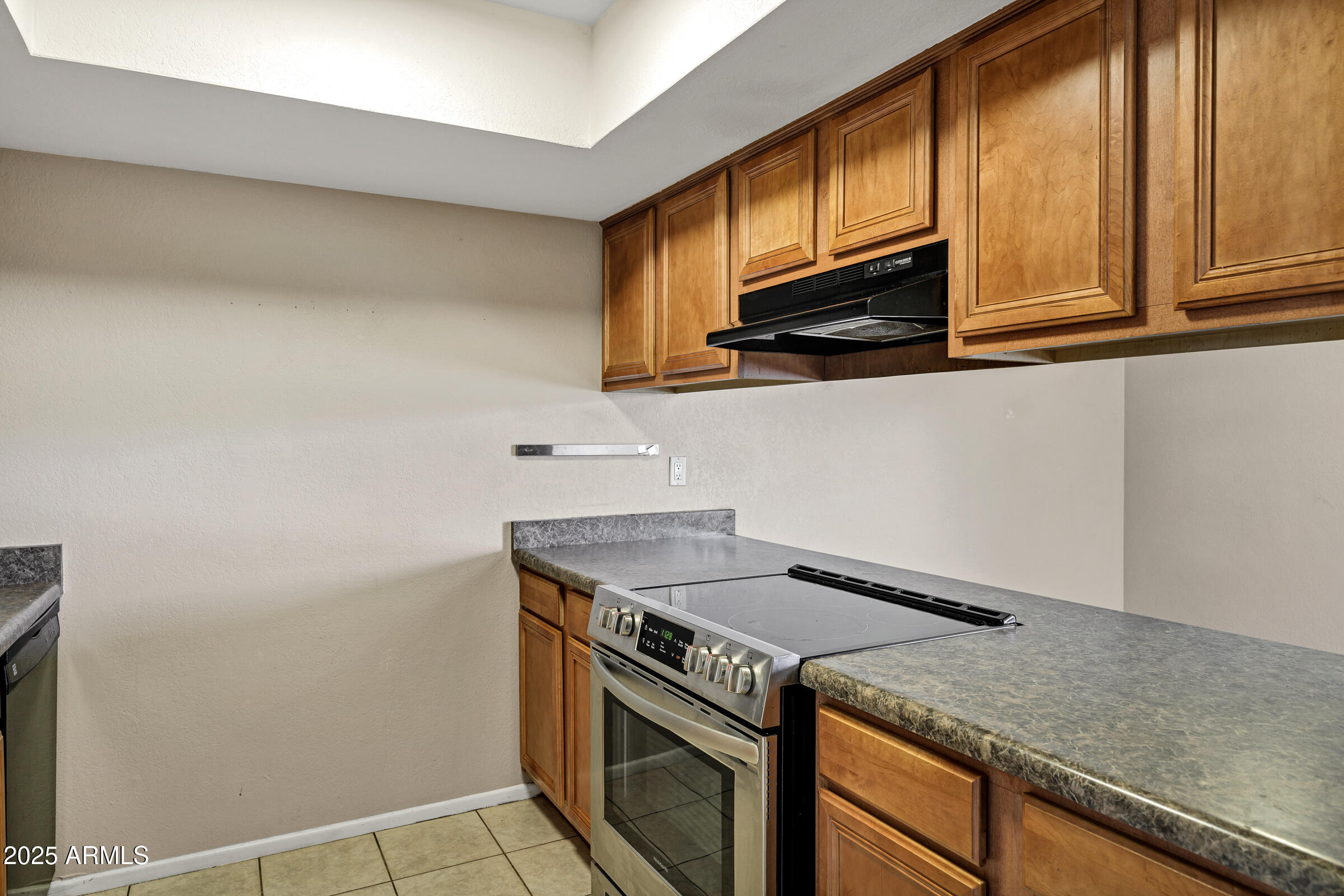 1402 East Guadalupe Road, Unit 248 Tempe, AZ 85283 - Photo 10 of 27 a kitchen with granite countertop a sink cabinets and stainless steel appliances