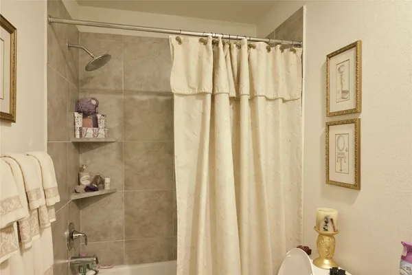 a bathroom with a shower and a tub