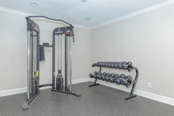 a view of a white house with large windows and a small yard