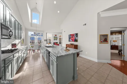 a living room with furniture and a kitchen view