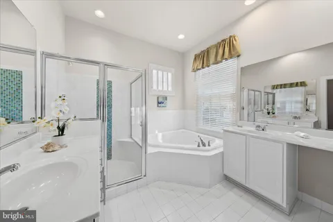 a bedroom with two beds and window