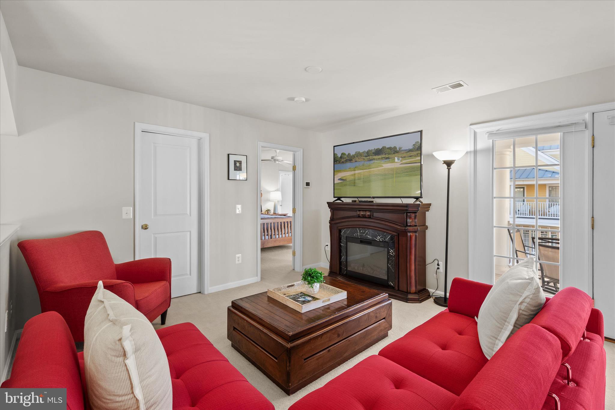 33067 Secluded Path, Unit 125 Millsboro, DE 19966 - Photo 40 of 64 a living room with furniture fireplace and a flat screen tv