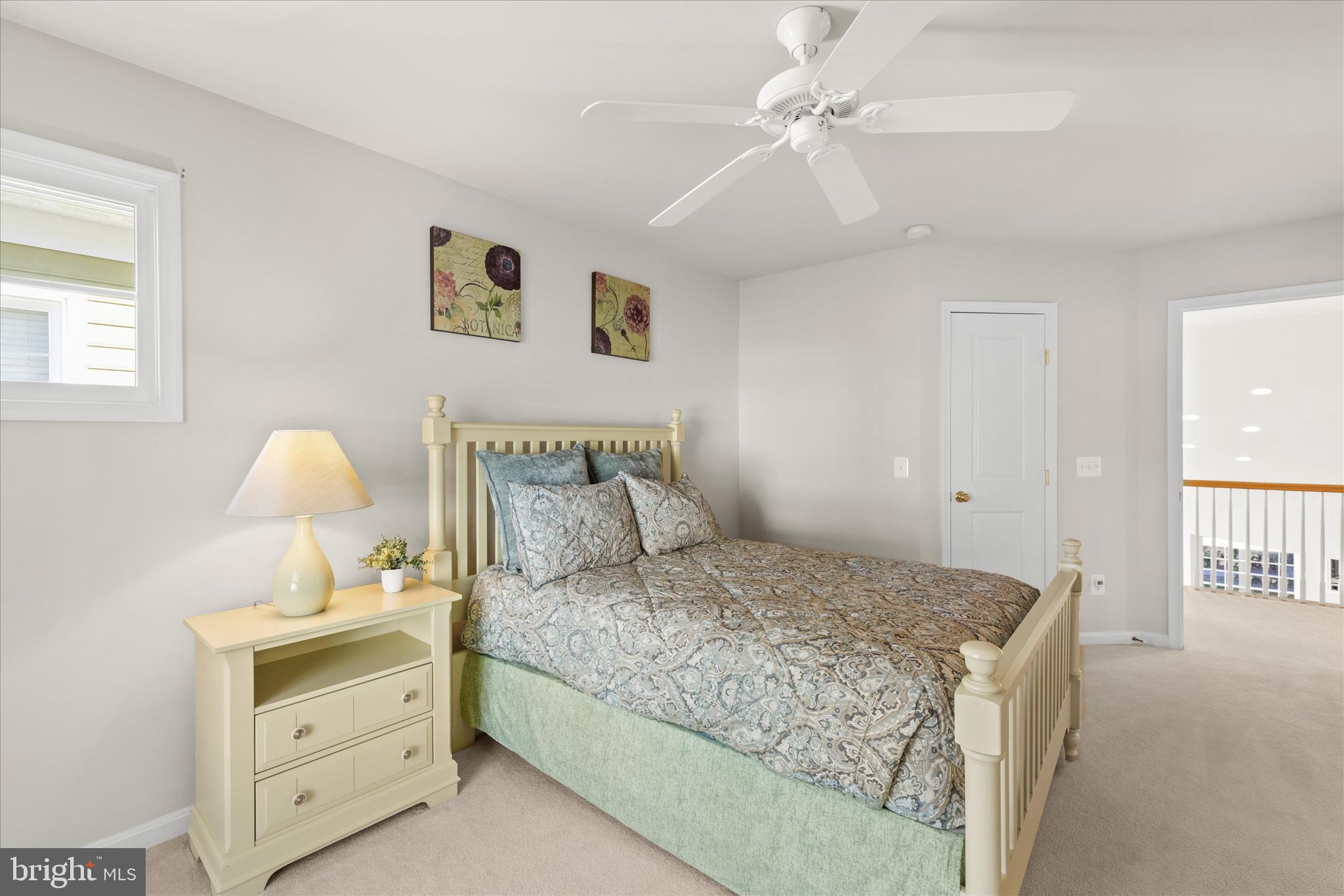 33067 Secluded Path, Unit 125 Millsboro, DE 19966 - Photo 48 of 64 a bedroom with a bed and a chandelier