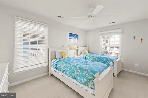 a view of a balcony with chairs and wooden floor