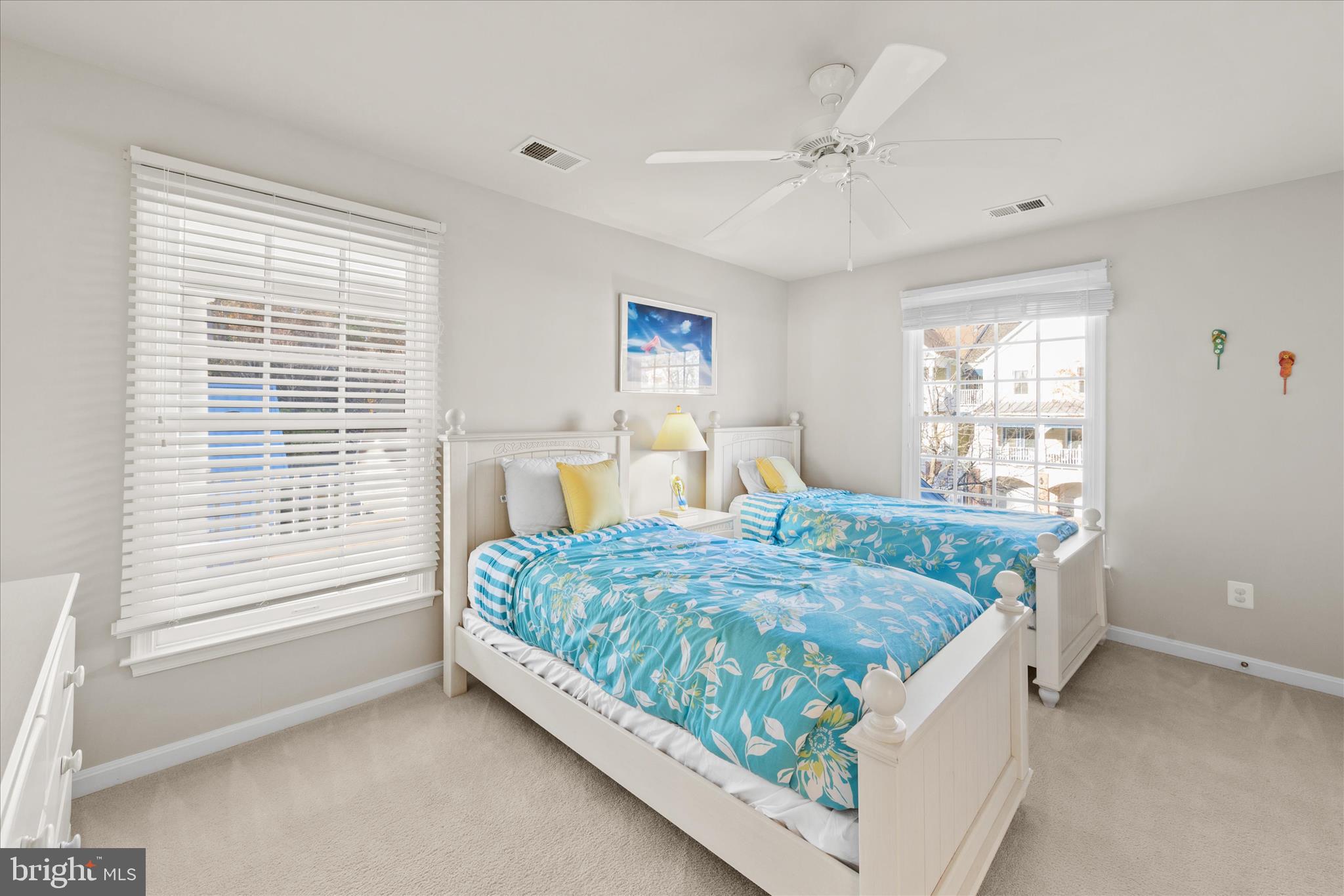 33067 Secluded Path, Unit 125 Millsboro, DE 19966 - Photo 49 of 64 a bed sitting in a bedroom next to a window