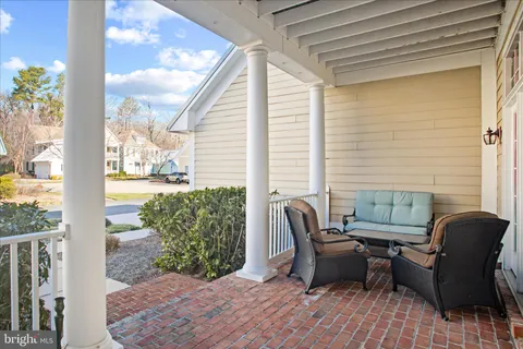 a view of a dining room with furniture a chandelier and wooden floor