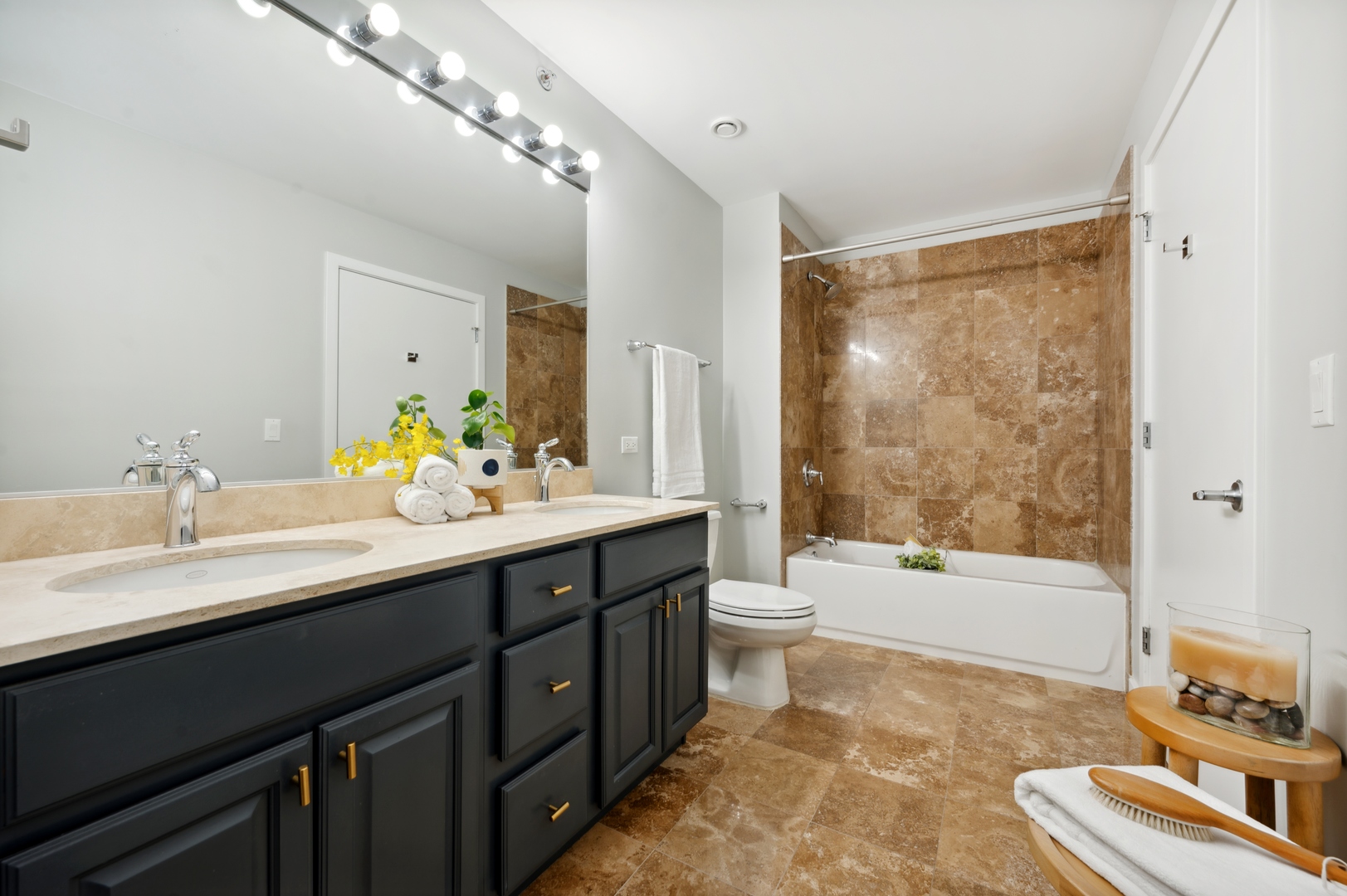 1224 West Van Buren Street, Unit 300 Chicago, IL 60607 - Photo 11 of 18 a bathroom with a tub a sink and a large mirror