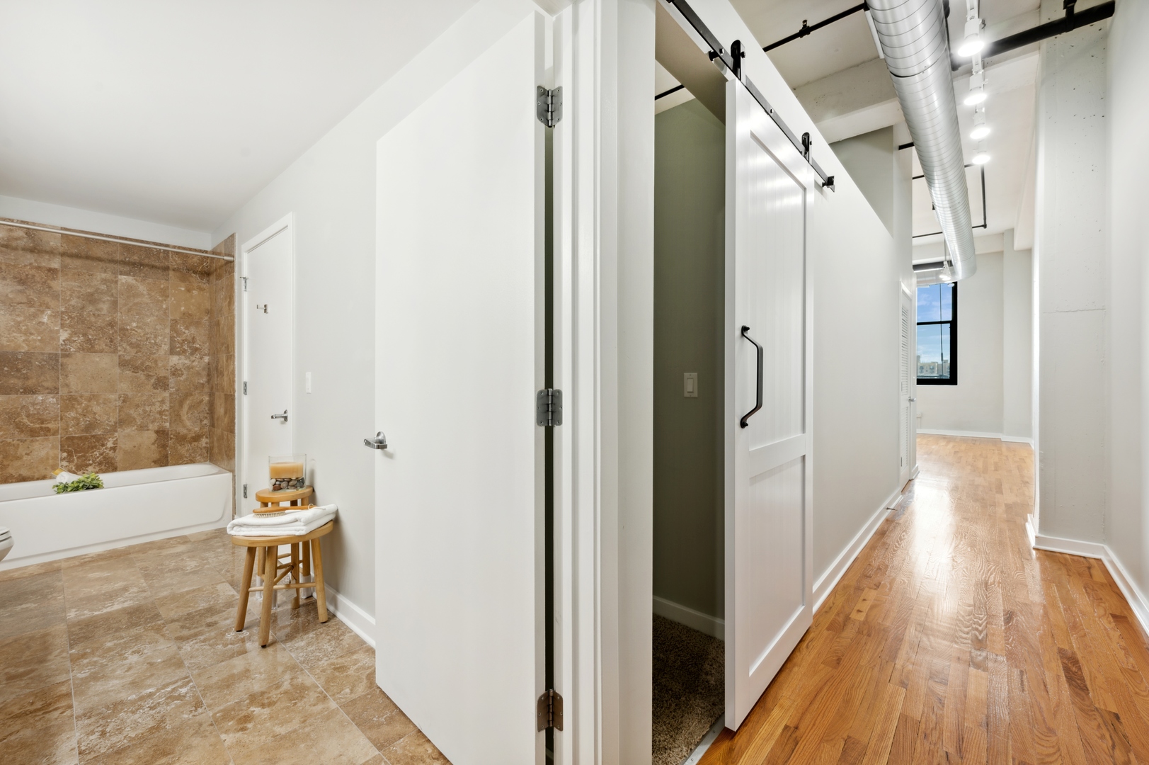 1224 West Van Buren Street, Unit 300 Chicago, IL 60607 - Photo 10 of 18 a view of a hallway with wooden floor and staircase