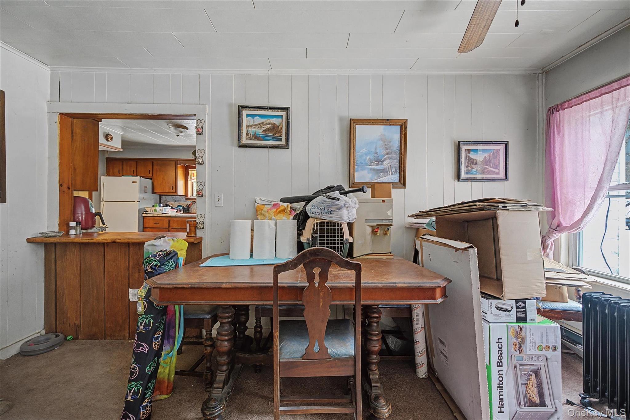 2 Station Hill Road, Unit 4 Ferndale, NY 12734 - Photo 9 of 25 Dining area featuring wooden walls, ceiling fan, and carpet